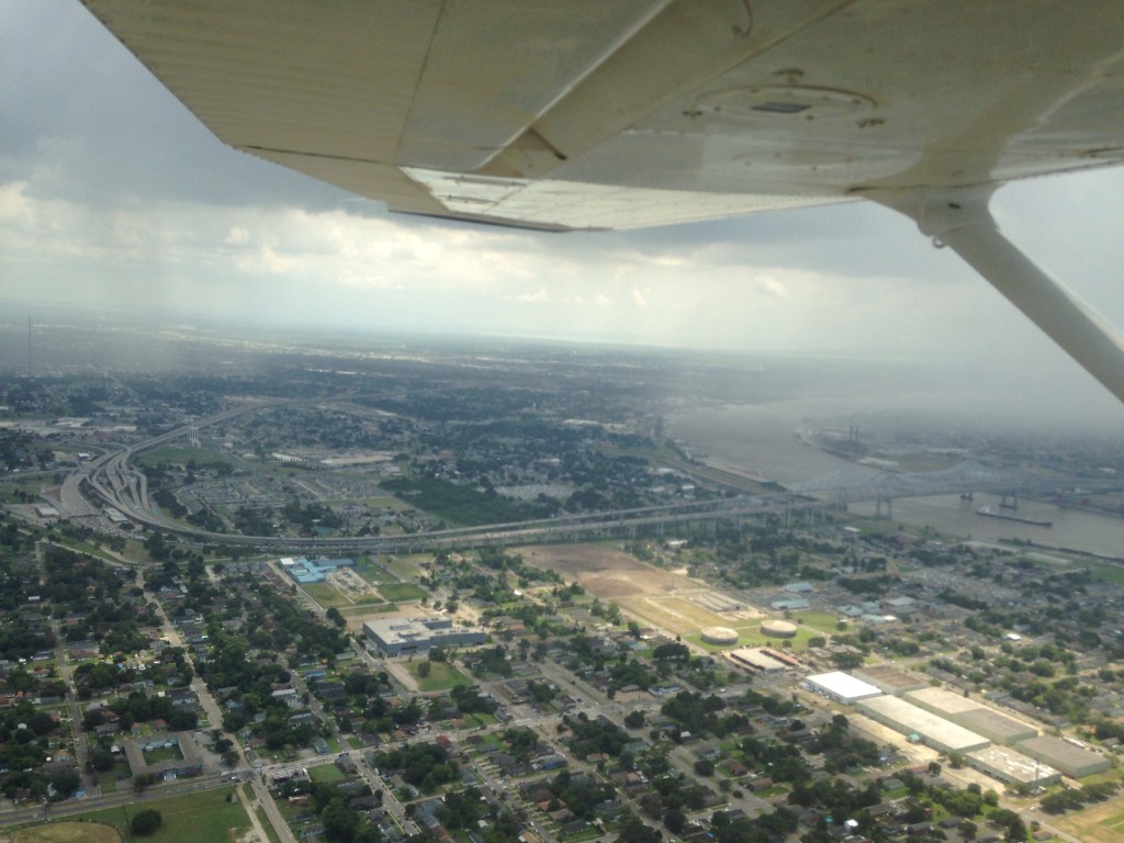 Flying over the West Bank while looking out over the Crescent City Connection and the Mississippi River during a sporadic rain.